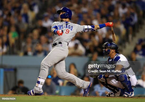 Javier Baez of the Chicago Cubs connects for a grandslam as Austin Barnes of the Los Angeles Dodgers looks on during the sixth inning of a game at...