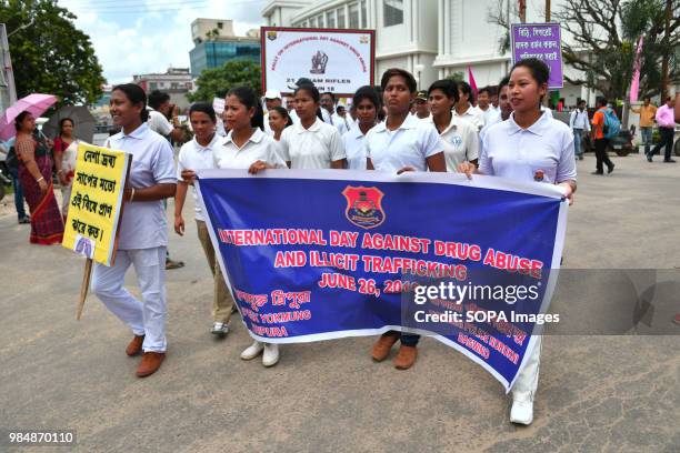 Female members of Indian Paramilitary Force and Indian Police holding a poster and a banner during the rally. Member of Indian Paramilitary Force and...