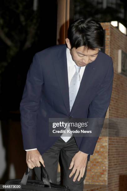 Kei Moriya, fiance of Japanese Princess Ayako, bows to reporters as he returns home in Tokyo on June 26 after their engagement was announced earlier...