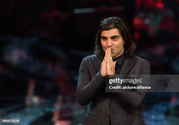 Fatih Akin gives thanks on receiving the award for directing "Aus dem Nichts" during the award ceremony of the 39th Bavarian Film Award at the Prince...