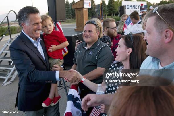 Mitt Romney, Republican U.S Senate candidate, left, greets supporters during an election night rally in Provo, Utah, U.S., on Tuesday, June 26, 2018....