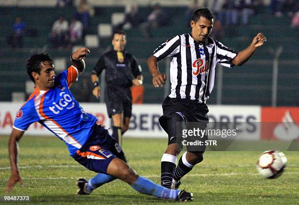 David Villalba of Bolivia's Blooming vies for the ball with Javier Gonzalez of Paraguayan Libertad on April 15 during a Libertadores Cup football...