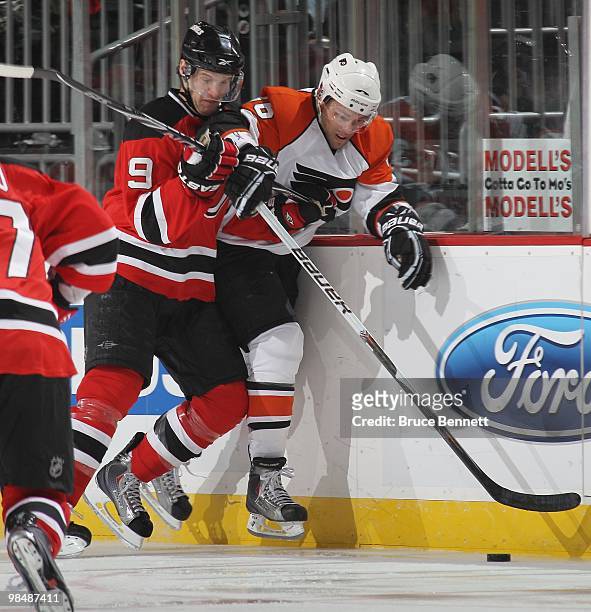 Darroll Powe of the Philadelphia Flyers skates against Travis Zajac of the New Jersey Devils in Game One of the Eastern Conference Quarterfinals...