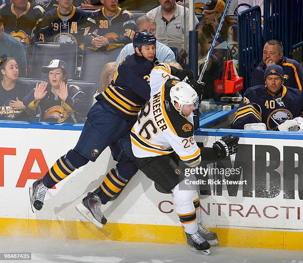 Matt Ellis of the Buffalo Sabres and Blake Wheeler of the Boston Bruins collide in Game One of the Eastern Conference Quarterfinals during the 2010...