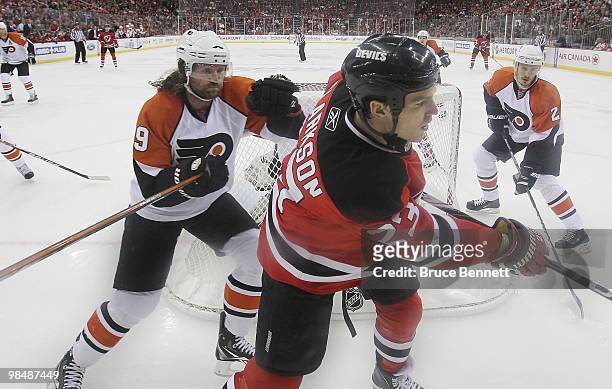 Scott Hartnell of the Philadelphia Flyers checks David Clarkson of the New Jersey Devils in Game One of the Eastern Conference Quarterfinals during...
