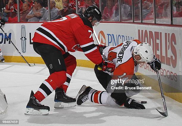 Ian Laperriere of the Philadelphia Flyers is checked by Paul Martin of the New Jersey Devils in Game One of the Eastern Conference Quarterfinals...