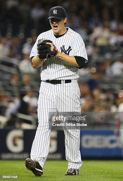 Phil Hughes of the New York Yankees reacts after striking out catcher Mike Napoli the second inning against the Los Angeles Angels of Anaheim on...