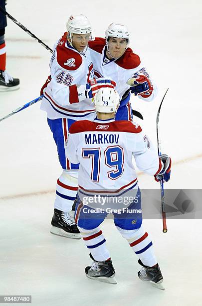 Michael Cammalleri of the Montreal Canadiens celebrates with teammates Andrei Kostitsyn and Andrei Markov after scoring in the first period against...