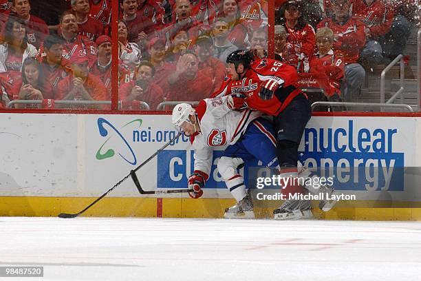Jason Chimera of the Washington Capitals fights for a loose puck against Josh Gorges of the Montreal Canadiens during Game One of the Eastern...