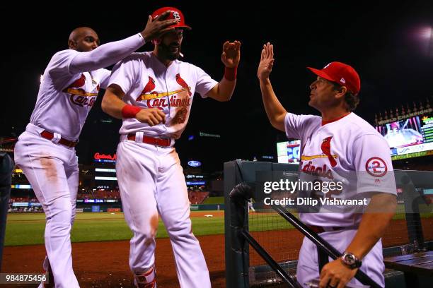 Matt Carpenter of the St. Louis Cardinals is congratulated by manager Mike Matheny of the St. Louis Cardinals after hitting a home run against the...