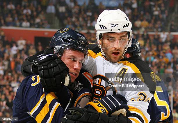 Derek Roy of the Buffalo Sabres and Patrice Bergeron of the Boston Bruins get tangled up during a first period skirmish at Game One of the Eastern...