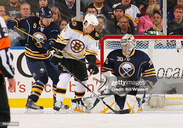 Ryan Miller and Toni Lydman of the Buffalo Sabres stop Marco Sturm of the Boston Bruins in Game One of the Eastern Conference Quarterfinals during...