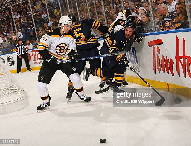 Miroslav Satan of the Boston Bruins battles for the puck against Derek Roy of the Buffalo Sabres in Game One of the Eastern Conference Quarterfinals...