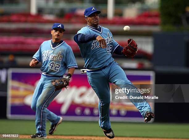 Yunel Escobar of the Atlanta Braves makes a bare-hand catch and throw for an out against the San Diego Padres at Petco Park on April 15, 2010 in San...