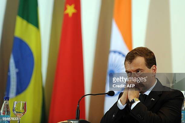 Russia's President Dmitri Medvedev listens during a press conference offered along with Brazilian President Luiz Inacio Lula da Silva, China's...