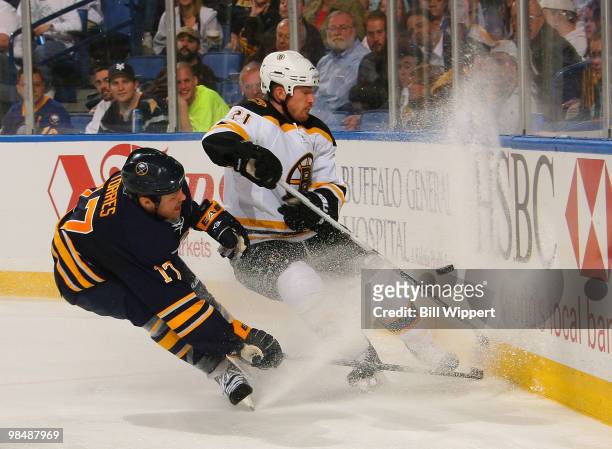 Raffi Torres of the Buffalo Sabres chases down a puck against Andrew Ference of the Boston Bruins in Game One of the Eastern Conference Quarterfinals...