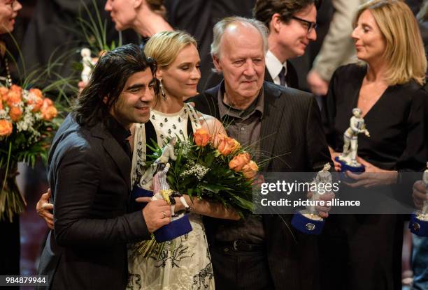 Film director Fatih Akin , actress Diane Kruger and director Werner Herzog stand next to each holding their trophies in their hands after the award...