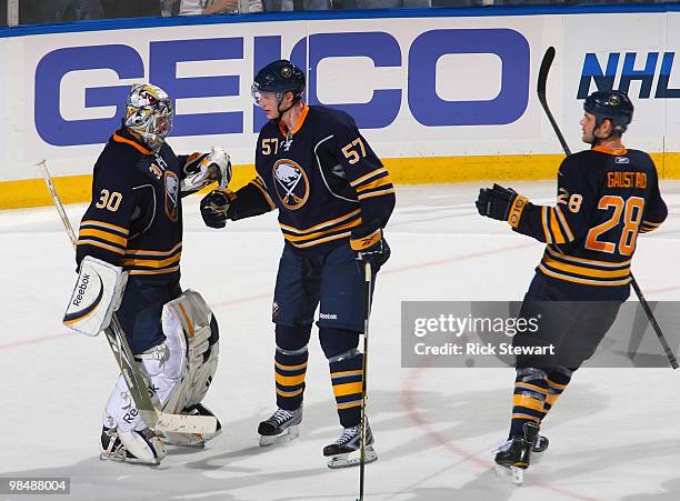 Ryan Miller#30, Tyler Myers and Paul Gaustad of the Buffalo Sabres celebrate defeating the Boston Bruins in Game One of the Eastern Conference...