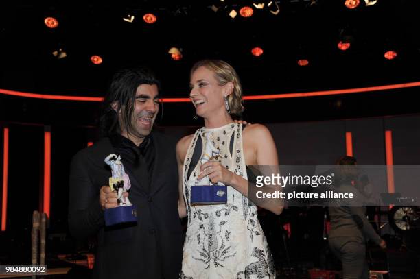 Film director Fatih Akin and actress Diane Kruger stand next to each holding their trophies in their hands after the award ceremony of the Bavarian...