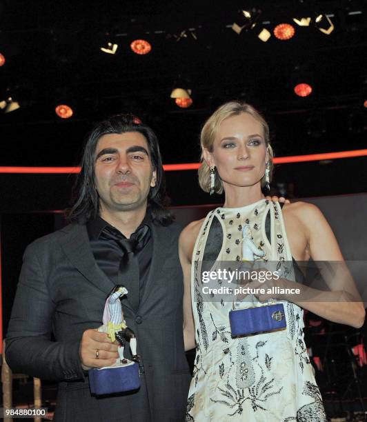 Film director Fatih Akin and actress Diane Kruger stand next to each holding their trophies in their hands after the award ceremony of the Bavarian...