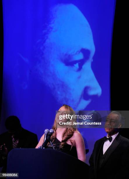 Singer Mariah Carey is joined on stage by her husband Nick Canon and the Reverend Al Sharpton as she receives the James Brown Cultural Excellence...