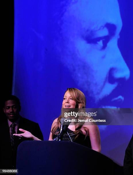 Singer Mariah Carey is joined on stage by her husband Nick Canon and the Reverend Al Sharpton as she receives the James Brown Cultural Excellence...