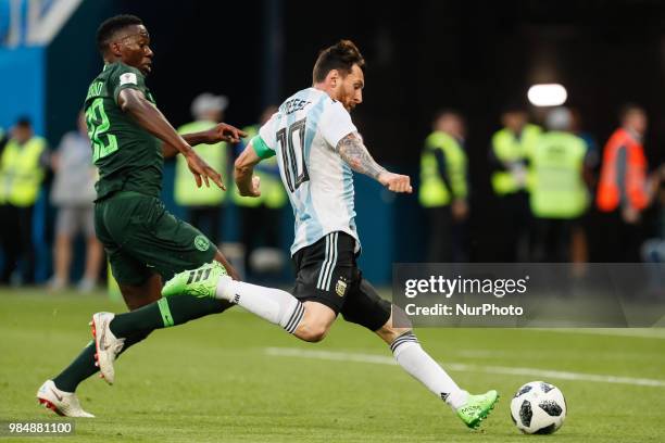 Kenneth Omeruo of Nigeria national team defends as Lionel Messi of Argentina national team shoots to score a goal during the 2018 FIFA World Cup...