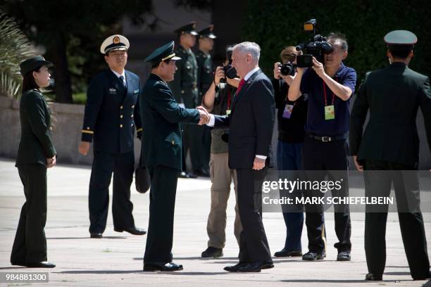 Defence Secretary Jim Mattis shakes hands with China's Defence Minister Wei Fenghe as he arrives for a welcome ceremony at the Bayi Building in...