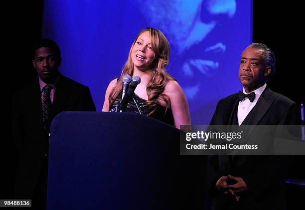 Singer Mariah Carey is joined on stage by her husband Nick Canon and the Reverend Al Sharpton as she receives the James Brown Cultural Excellence...