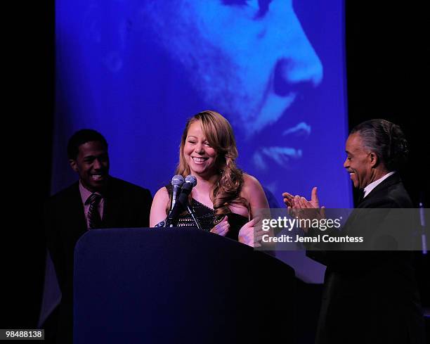 Singer Mariah Carey is joined on stage by her husband Nick Canon and the Reverend Al Sharpton as she receives the James Brown Cultural Excellence...