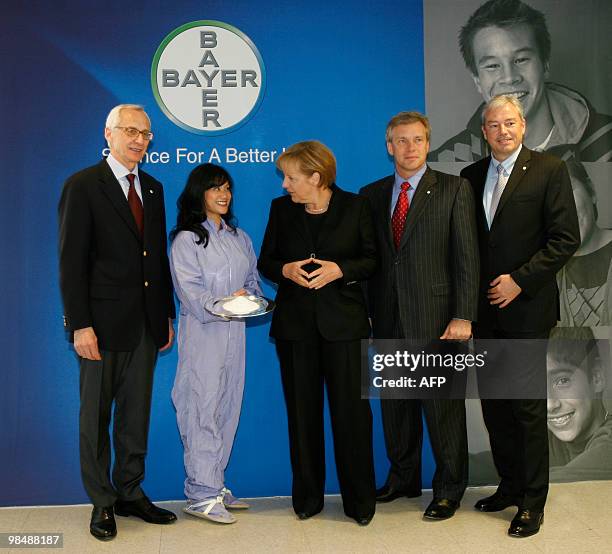 German Chancellor Angela Merkel meets with Dr. Wolfgang Plischke, Member of the Board of Bayer in Germany, an unidentified employee from Bayer,...