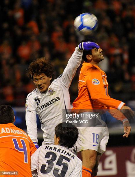 Tomoaki Makino of Sanfrecce Hiroshima competes for a ball with Roda Antar of Shandong Luneng during the AFC Champions League between Shandong Luneng...