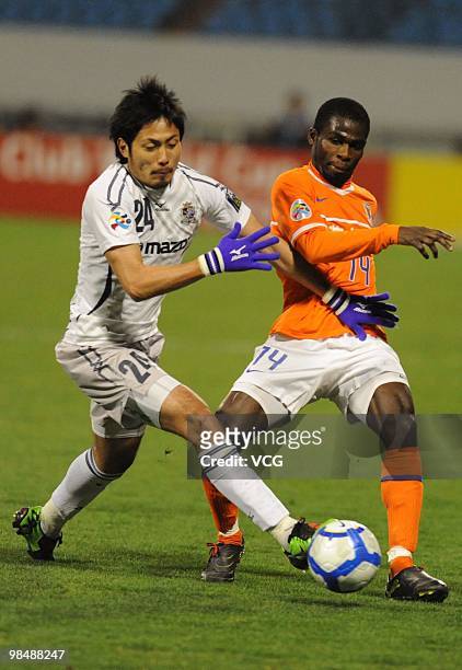 Ryota Moriwaki of Sanfrecce Hiroshima competes for a ball with Fred Benson of Shandong Luneng during the AFC Champions League between Shandong Luneng...