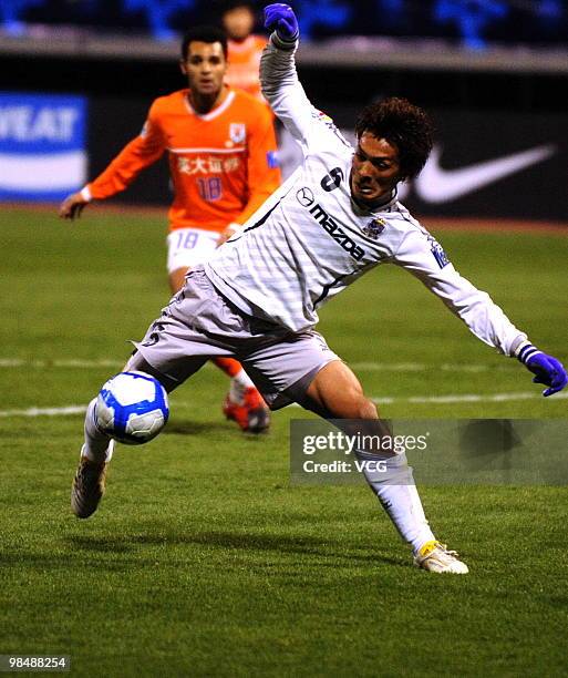 Tomoaki Makino of Sanfrecce Hiroshima aims a ball during the AFC Champions League between Shandong Luneng and Sanfrecce Hiroshima on April 13, 2010...