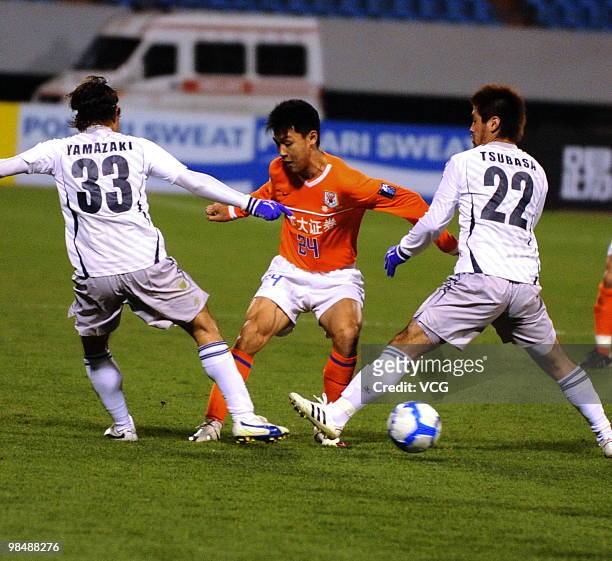 Lu Zheng of Shandong Luneng competes for a ball with Masato Yamazaki and Tsubasa Yokotake of Sanfrecce Hiroshima during the AFC Champions League...