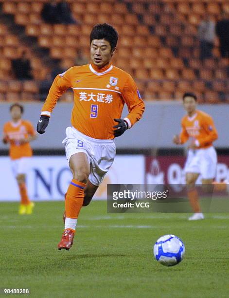 Han Peng of Shandong Luneng aims a ball during the AFC Champions League between Shandong Luneng and Sanfrecce Hiroshima on April 13, 2010 in Jinan,...