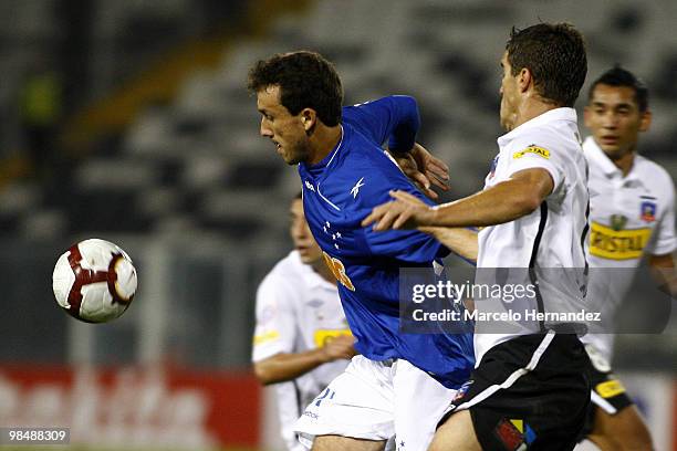 Andres Scotti of Colo Colo fights for the ball with Thiago Ribeiro of Cruzeiro during a match as part of the Libertadores Cup on April 15, 2010 in...