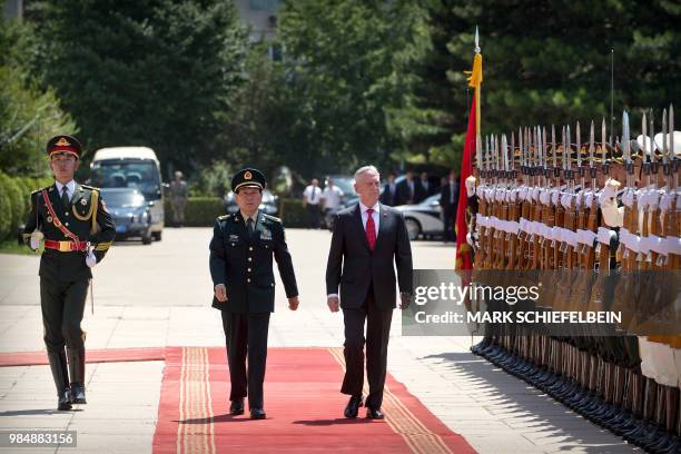 China's Defence Minister Wei Fenghe and US Defence Secretary Jim Mattis review an honour guard during a welcome ceremony at the Bayi Building in...