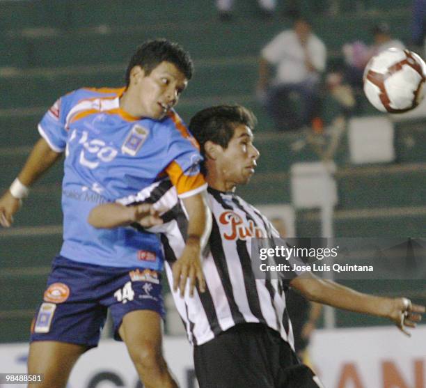 Jorge Andia of Blooming fights for the ball with player of Libertad during a match at Ramon Aguilera Costa Stadium on April 15, 2010 in Santa Cruz,...