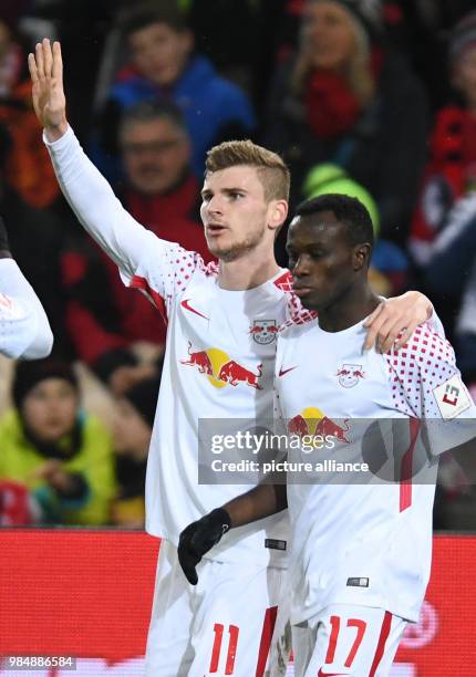 Freiburg and RB Leipzig face off in a Bundesliga match at Freiburg/Breisgau, Germany, 20 January 2018. Leipzig's Timo Werner congratulates Bruma's...