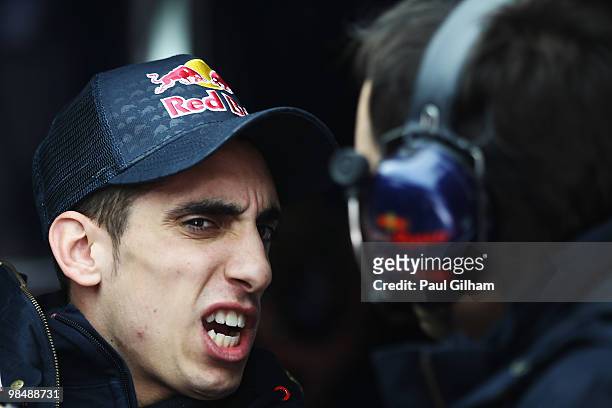 Sebastien Buemi of Switzerland and Scuderia Toro Rosso reacts in his team garage after an accident in which both his front wheels detached from his...