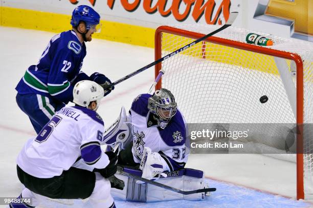 Daniel Sedin of the Vancouver Canucks fires the puck past goalie Jonathan Quick of the Los Angeles Kings as Sean O'Donnell of the Kings tries to help...