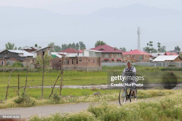 Man on his bicycle can be seen in the outskirts of Sopore Town of District Baramulla, Jammu and Kashmir, India, on 27 June 2018.