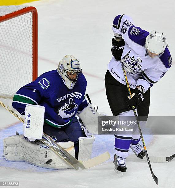 Goalie Roberto Luongo of the Vancouver Canucks stops the redirected shot of Fredrik Modin of the Los Angeles Kings during the second period in Game...