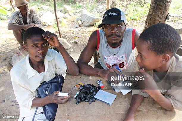 Haitians are pictured on April 14, 2010 in Parques, a remote town south of Leogane, Haiti, where the United Nations World Food Program is...