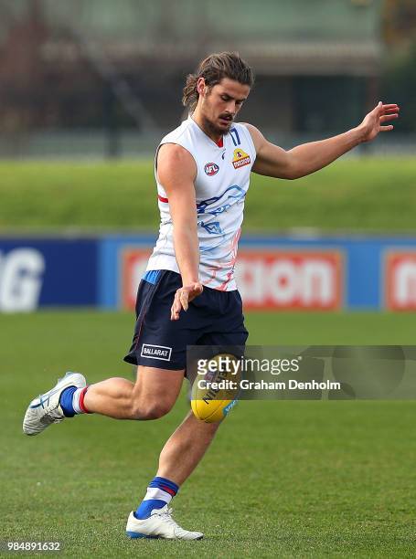 Tom Boyd of the Bulldogs kicks during a training session at Whitten Oval on June 27, 2018 in Melbourne, Australia.