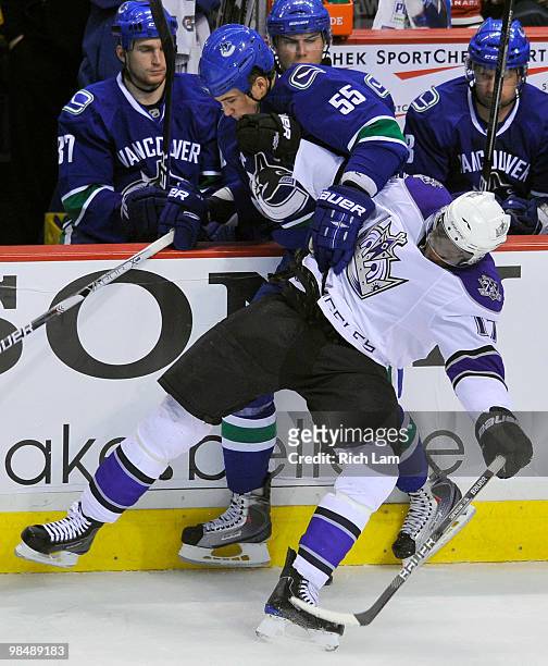 Shane O'Brien of the Vancouver Canucks and Wayne Simmonds of the Los Angeles Kings get tangled up along the side boards during the third period in...