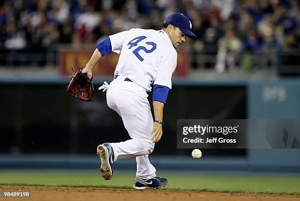 Second baseman Jamey Carroll of the Los Angeles Dodgers bobbles the ball but is able to throw out John Hester of the Arizona Diamondbacks in the...