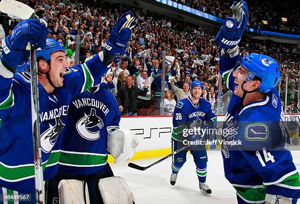 Alex Burrows and Shane O'Brien of the Vancouver Canucks celebrate the game-winning goal during overtime in Game One of the Western Conference...