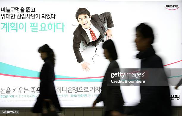 Pedestrian walks past an advertisement for Hana Bank in Seoul, South Korea, on Friday, April 16, 2010. Hana Financial Group Inc. Is expected to...